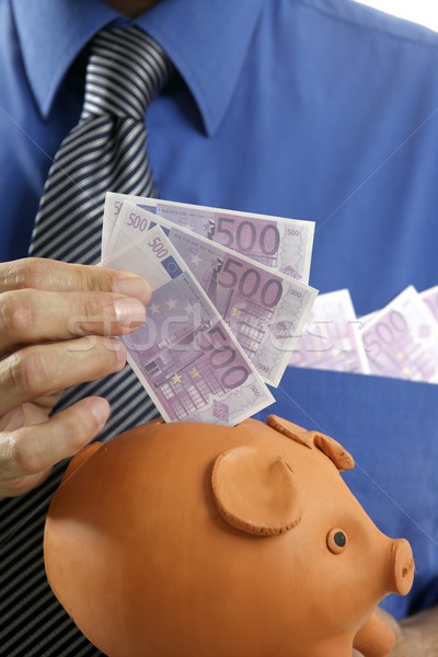 businessman insert euro notes in piggy bank Stock photo © lunamarina