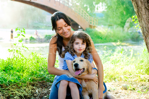 daughter and mother with golden retriever Stock photo © lunamarina