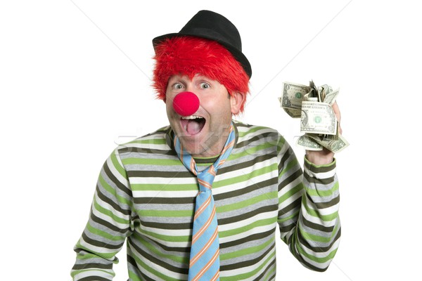 Stock photo: Clown with many dollar notes in hand