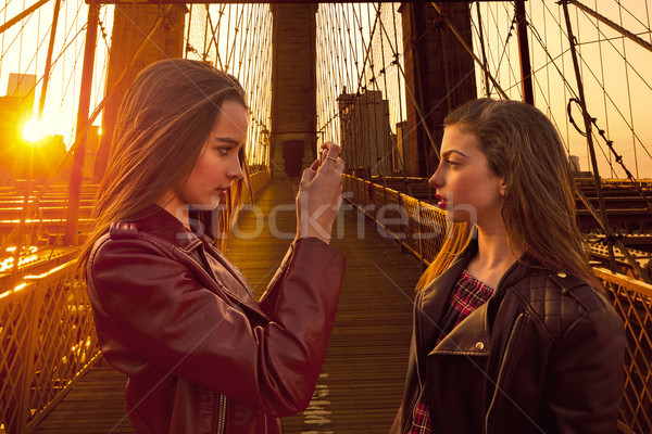 Teen tourist girls taking photo in Brooklyn bridge NY Stock photo © lunamarina