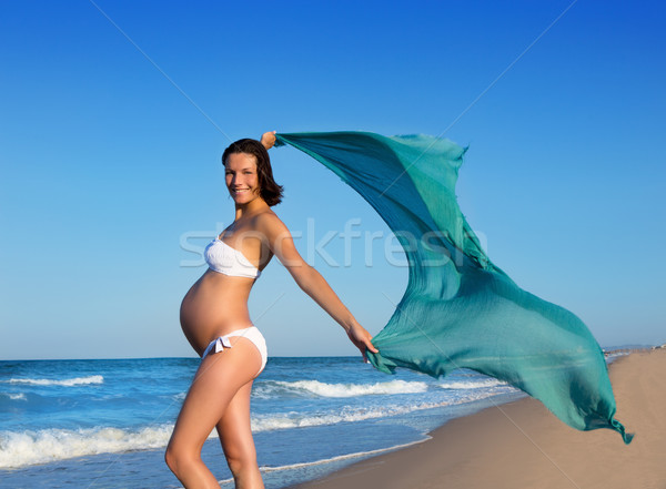 Beautiful pregnant woman walking on blue beach Stock photo © lunamarina