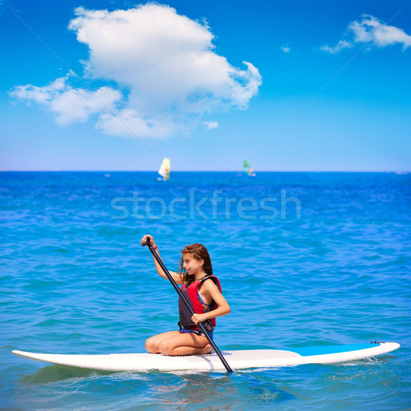 Kid paddle surf surfer girl with row in the beach Stock photo © lunamarina