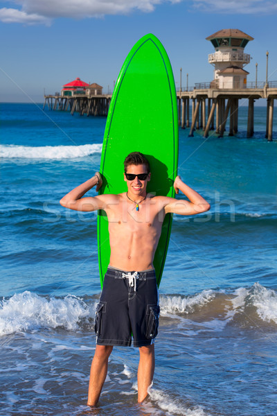 Stock photo: Boy teen surfer holding surfboard in the beach