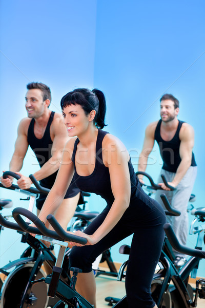 Stationary spinning bicycles fitness girl in a gym Stock photo © lunamarina