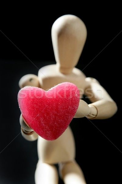 Wooden mannequin holding a red jelly  heart shape Stock photo © lunamarina