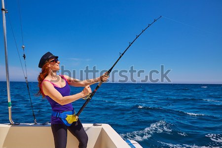 bikini fisher woman holding bluefin tuna on boat Stock photo © lunamarina