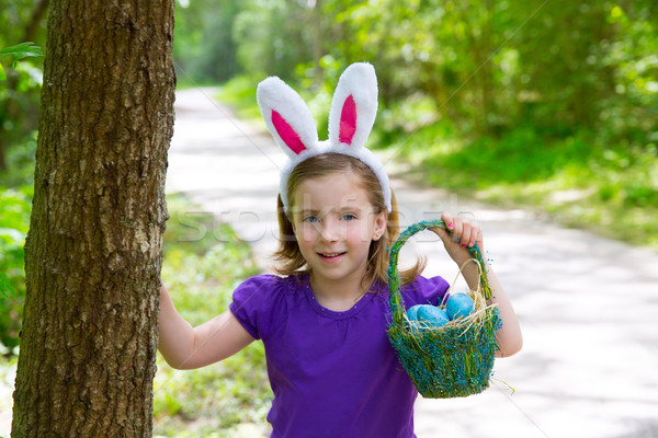 Easter girl with eggs basket and funny bunny ears Stock photo © lunamarina