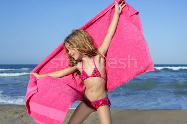 Beach little girl playing pink towel and wind Stock photo © lunamarina