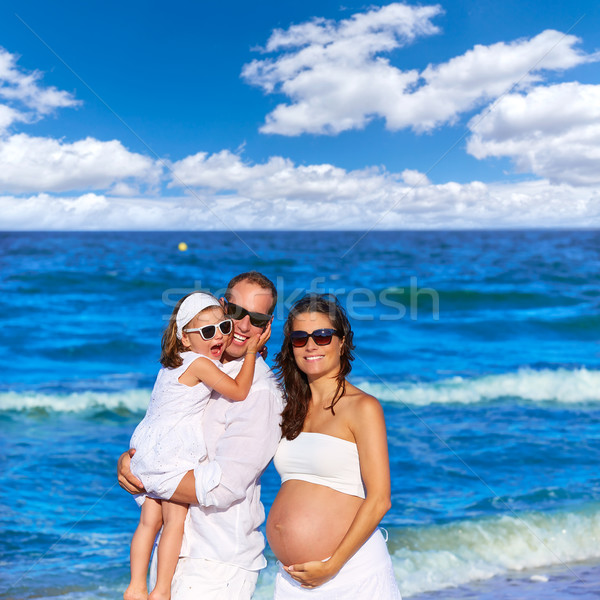 Family on the beach pregnant mother Stock photo © lunamarina