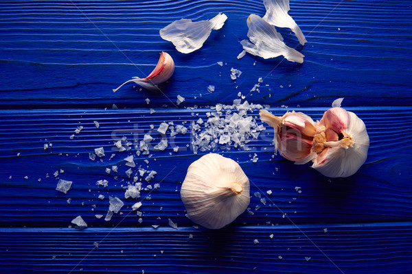 Garlic and salt spread on a blue wooden table Stock photo © lunamarina
