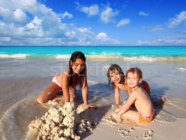 three little girls mixed ethnicity playing beach Stock photo © lunamarina