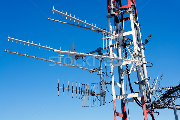 Antenna repeater messy mast in blue sky Stock photo © lunamarina