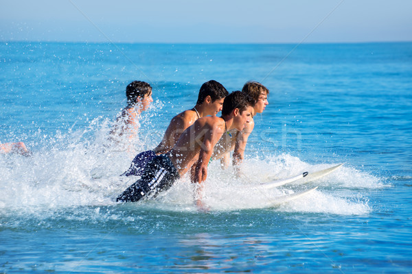 Boys surfers surfing running jumping on surfboards Stock photo © lunamarina