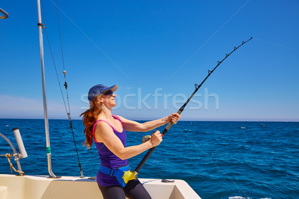 Beautiful woman girl fishing rod trolling in boat Stock photo © lunamarina