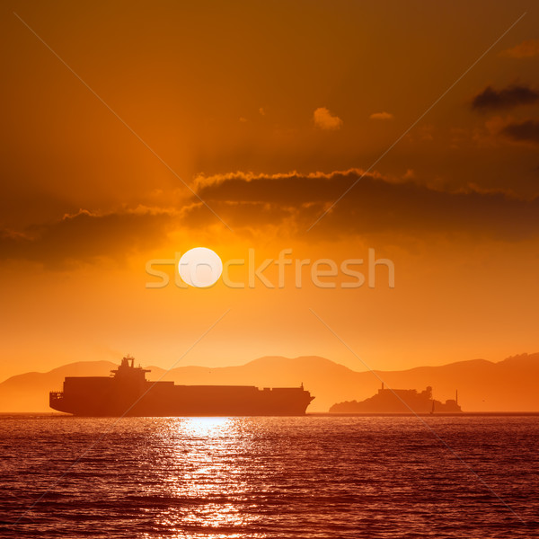 Alcatraz island penitentiary at sunset and merchant ship Stock photo © lunamarina