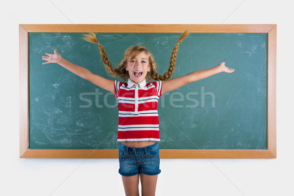 Braided student blond girl playing with braids Stock photo © lunamarina