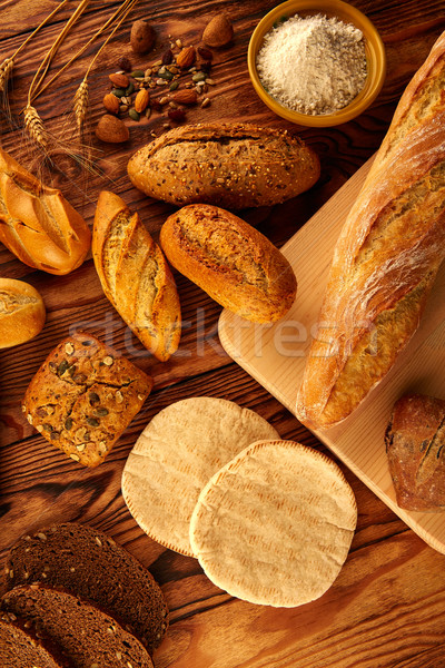 Bread varied mix on golden aged wood table Stock photo © lunamarina