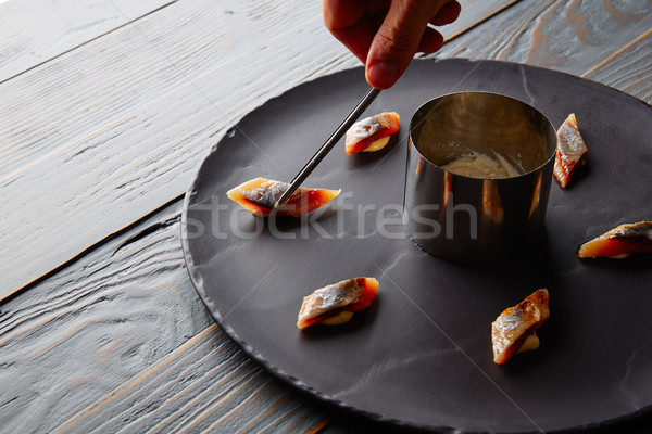 Bota sardine preparation with chef hand Stock photo © lunamarina