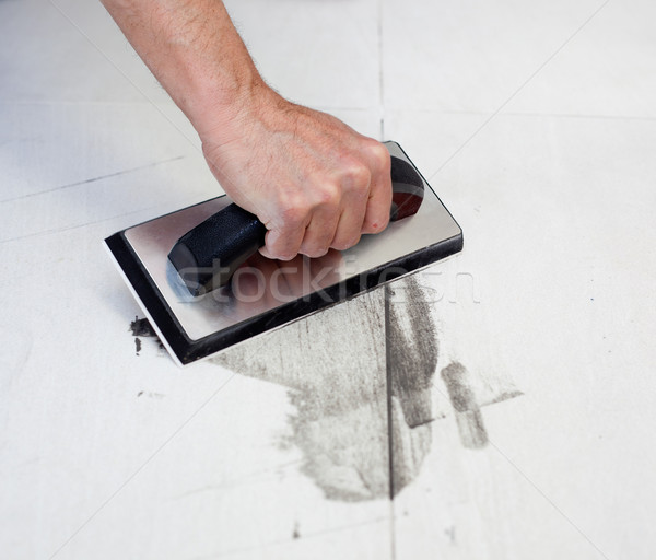 grouting tiles with rubber trowel man hand Stock photo © lunamarina