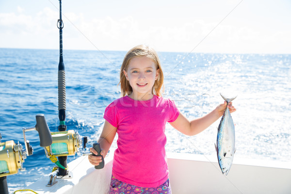 Blond kid girl fishing tuna little tunny happy with catch Stock photo © lunamarina