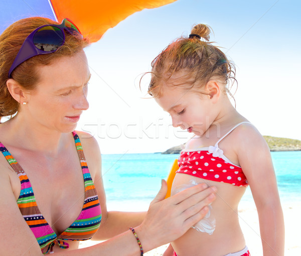 daughter and mother in beach with sunscreen Stock photo © lunamarina