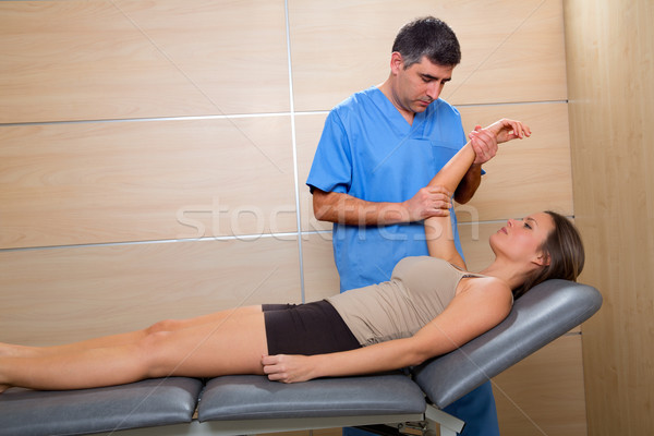 Shoulder physiotherapy doctor therapist and woman patient Stock photo © lunamarina