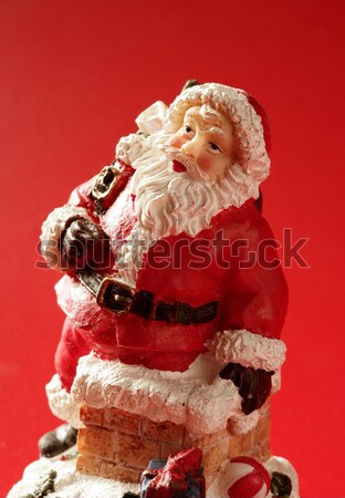 Santa Claus figurine over red background, studio Stock photo © lunamarina