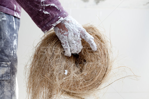 Plaster dirty hand with hemp for plasterboard Stock photo © lunamarina