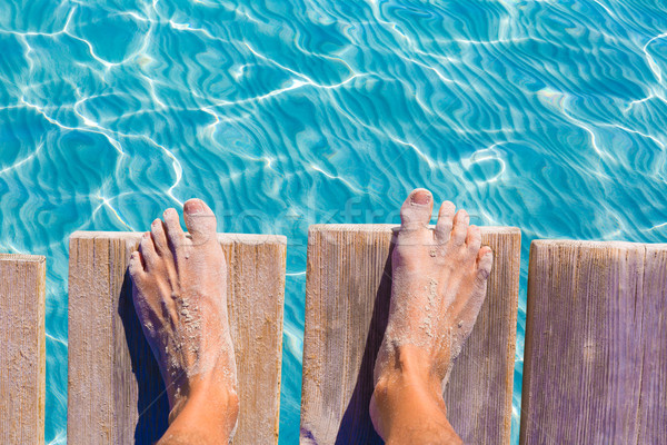 sandy feet on the pier tropical turquoise sea Stock photo © lunamarina