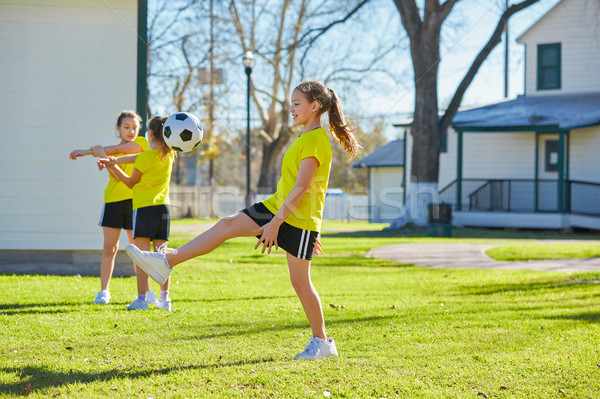 Friend girls teens playing football soccer in a park Stock photo © lunamarina