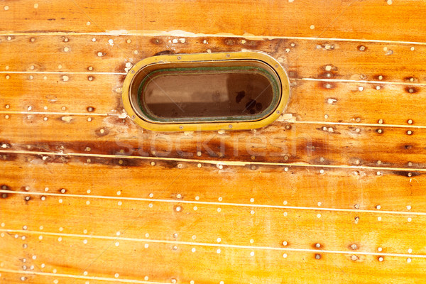 boat oval porthole in wooden hull Stock photo © lunamarina