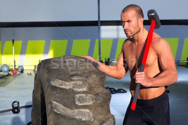 Crossfit sledge hammer man at gym relaxed Stock photo © lunamarina