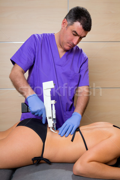 Back lumbar mesotherapy gun doctor with woman patient Stock photo © lunamarina