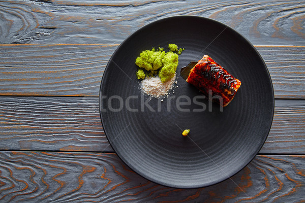Grilled smoked eel on black plate Stock photo © lunamarina