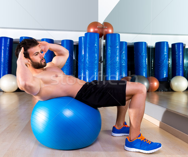 Fitball abdominal crunch Swiss ball man at gym Stock photo © lunamarina
