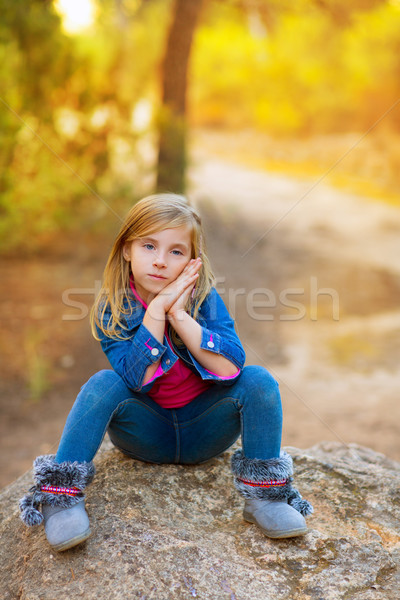 Stock photo: blond kid girl pensive in the forest outdoor sitting