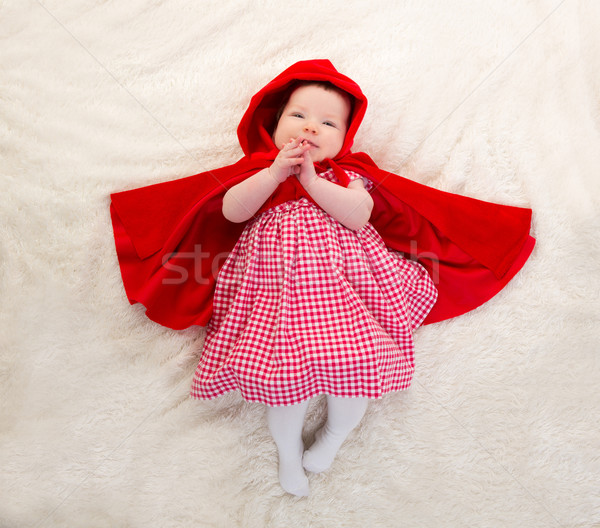 Baby Little Red Riding Hood on white fur Stock photo © lunamarina