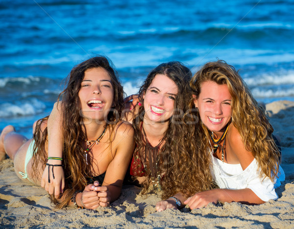 Girls friends having fun happy lying on the beach Stock photo © lunamarina