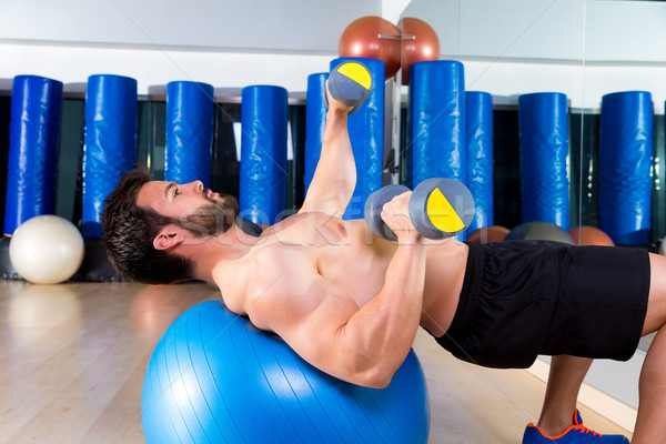 Stock photo: Dumbbell chest press on fit ball man workout