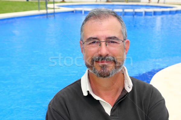 Senior smiling man vacation in blue pool happy Stock photo © lunamarina