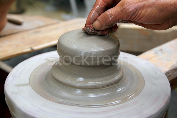 man potter hands working on pottery clay wheel Stock photo © lunamarina