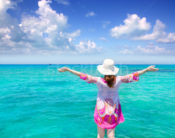 Beach hat woman rear view in Formentera beach with Ibiza background Stock photo © lunamarina