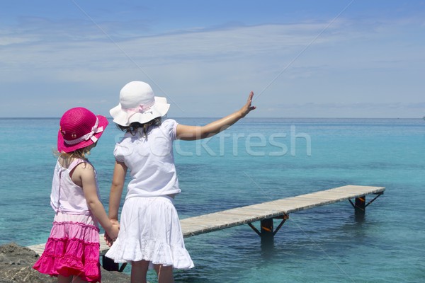 two girls tourist turquoise sea goodbye hand gesture Stock photo © lunamarina