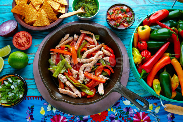Stock photo: chicken fajitas in a pan chili and sides Mexican