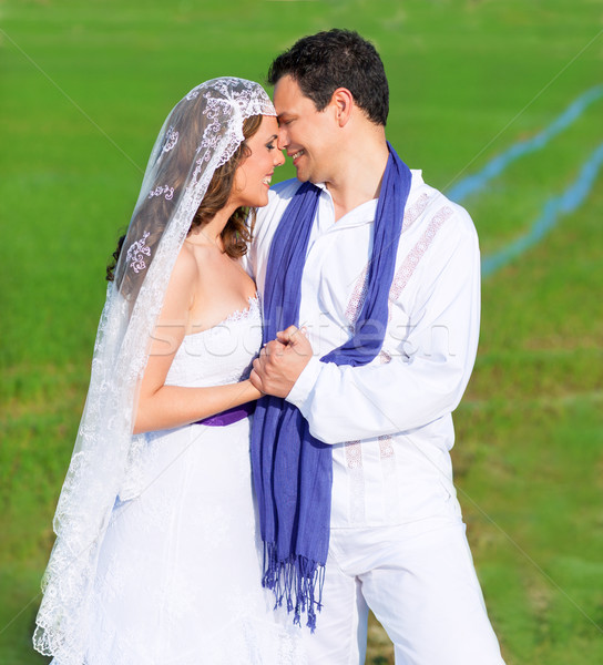 Couple in wedding day hug in green meadow Stock photo © lunamarina