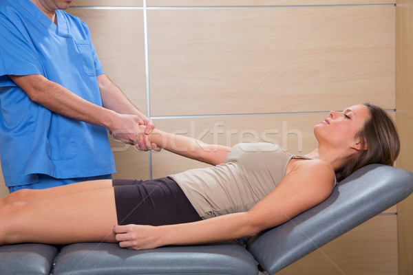 fascial therapy doctor pulling patient woman arm Stock photo © lunamarina