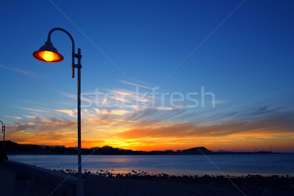 Sunset orange blue seascape light lamppost Stock photo © lunamarina