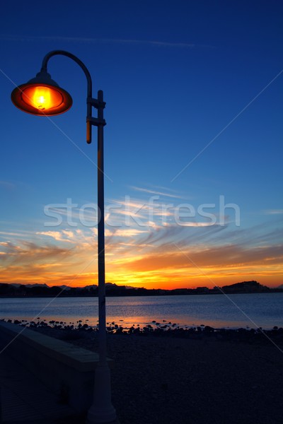 Sunset orange blue seascape light lamppost Stock photo © lunamarina
