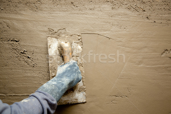 trowel with glove hand plastering cement mortar Stock photo © lunamarina