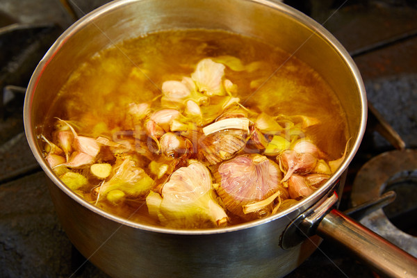 Stock photo: Garlic boiling soup in a pan